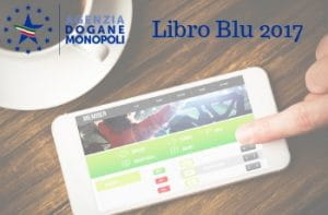 Smartphone con scommesse sportive online, logo Agenzia Dogane e Monopoli e Libro Blu 2017