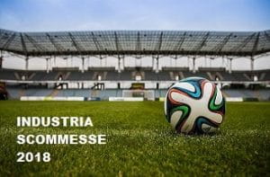 Un pallone da calcio sul prato in uno stadio e la scritta Industria scommesse 2018