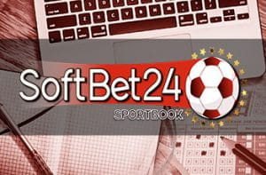 Il logo di SoftBet24 e sullo sfondo la tastiera di un laptop con una schedina, una penna e una matita