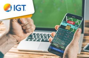 Il logo del gruppo IGT, uno smartphone connesso ad un sito di scommesse