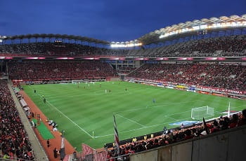 Uno stadio di calcio affollato durante una partita in notturna