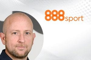 Itai Pazner, CEO di 888 Holdings, e il logo di 888sport