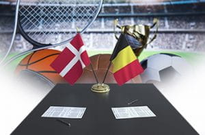 Le bandiere di Danimarca e Belgio, una scrivania e dei palloni di diversi sport