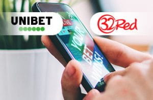 I loghi di Unibet e 32Red e uno smartphone collegato al sito di un bookmaker online