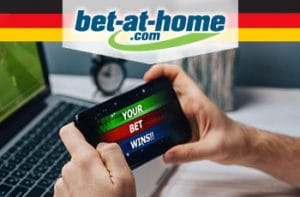 Il logo di bet-at-home, la bandiera tedesca e un telefonino collegato a un bookmaker online