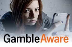 Donna triste con in mano uno smartphone, logo GambleAware