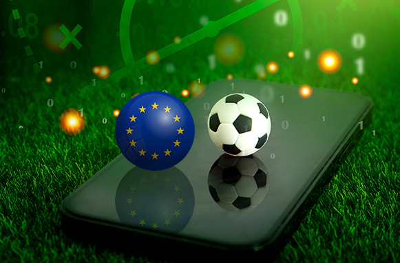 Smartphone, pallone da calcio e bandiera UE
